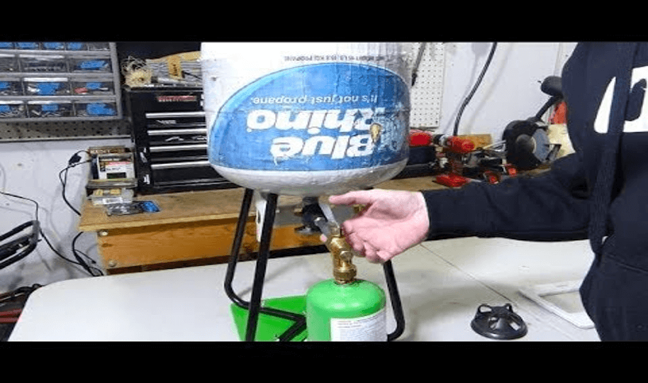 man refiling Propane Bottles