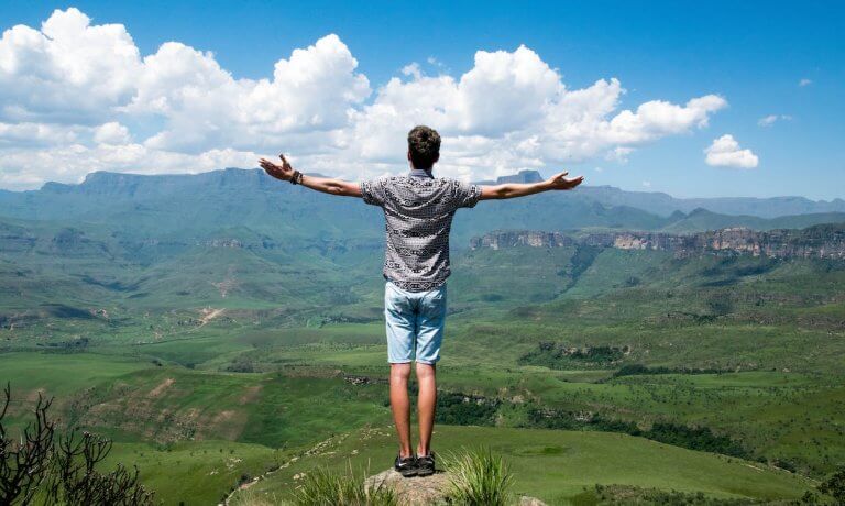 Free Man Wearing Grey Shirt Standing on Elevated Surface Stock Photo